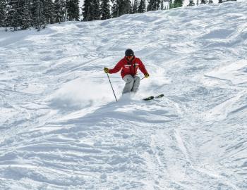 person downhill mogul skiing