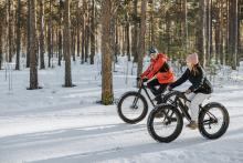 Man and woman enjoying winter mountain biking in Vermont