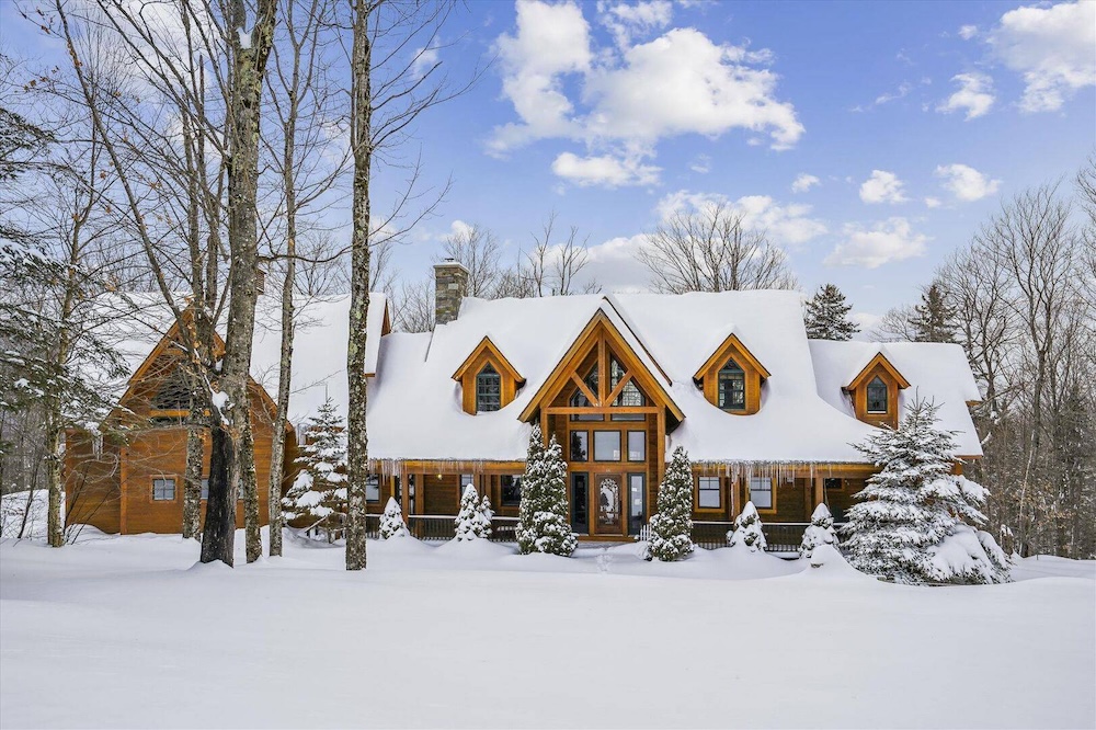 Exterior view of cabin covered in snow in Killington, VT