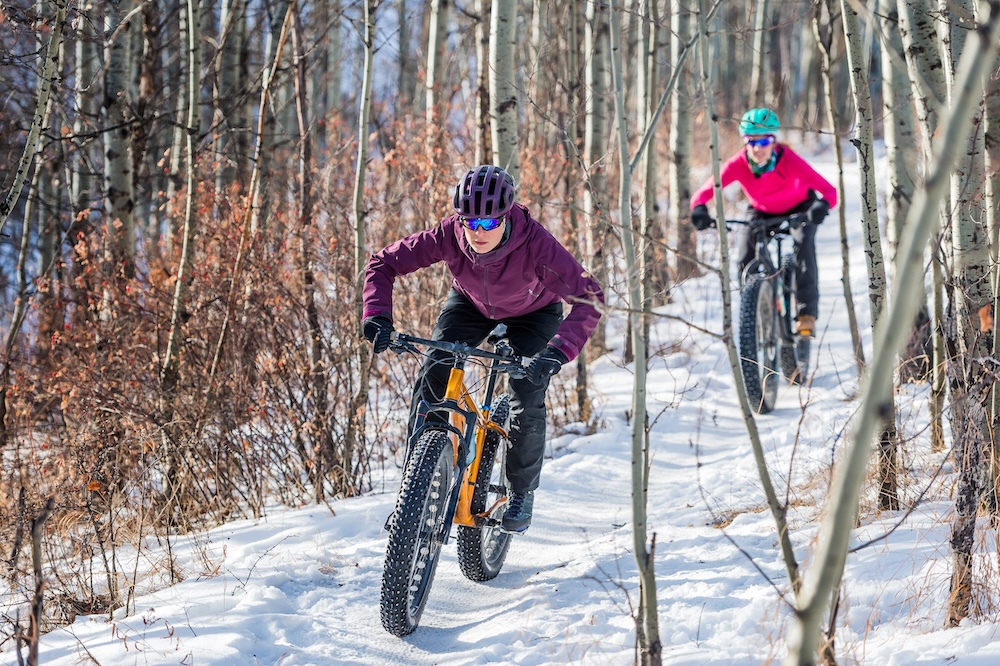 couple mountain biking in Vermont in winter