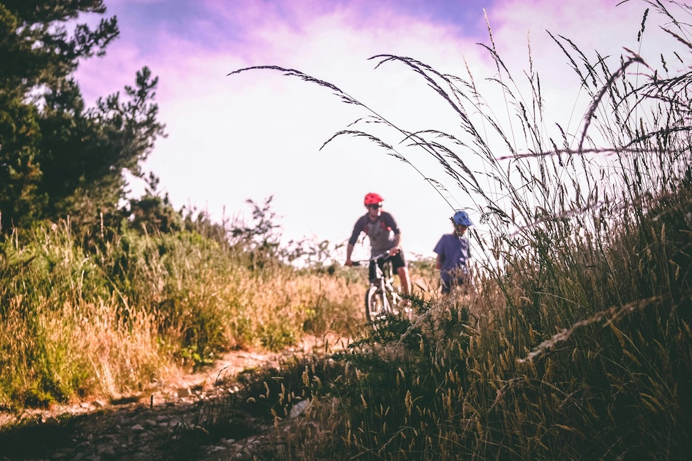 father and child mountain biking 